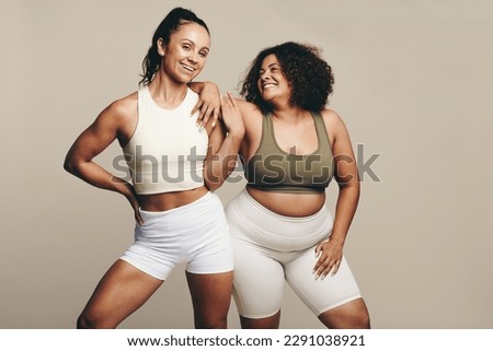 Sports women of different body types stand side by side, wearing fitness attire. Female athletes showing pride in their commitment to a fit and active lifestyle through training and exercise. Royalty-Free Stock Photo #2291038921
