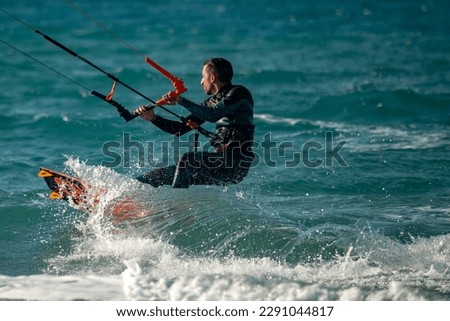 Kitesurfing. Surfers of all ages train in the Mediterranean. Israel, Ashkelon, January 2023 Training continues. Sport, health, recreation concept Royalty-Free Stock Photo #2291044817