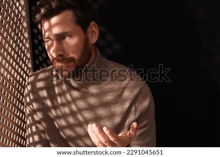 Man talking to priest during confession in booth, space for text Royalty-Free Stock Photo #2291045651