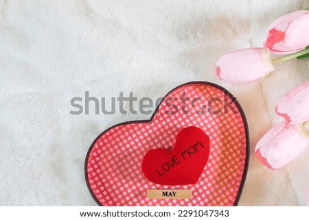 Everyday is mother's day. Mother's day concepts and Sweetest day, love concept. Red heart with the letter LOVE MOM with Beautiful flower on pink background.