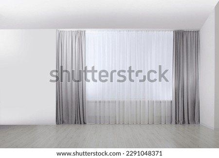 Light grey window curtains and white tulle indoors Royalty-Free Stock Photo #2291048371
