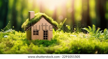 Green and environmentally friendly housing concept. Miniature wooden house in spring grass, moss and ferns on a sunny day. Eco house Royalty-Free Stock Photo #2291051505