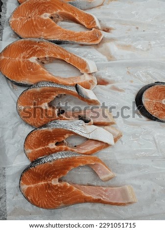 Pictures of sea foods and meat poultry being sold in a supermarket.