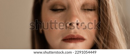 Portrait of young beautiful woman with closed eyes. Royalty-Free Stock Photo #2291054449