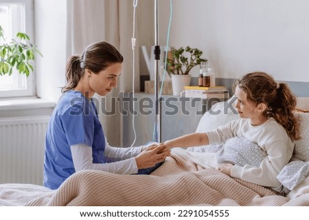 Young nurse taking care of teenage girl.