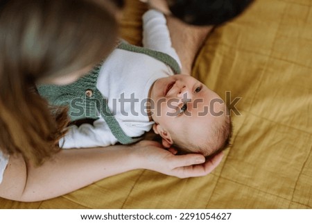 Happy parents cuddling with their newborn baby. Royalty-Free Stock Photo #2291054627