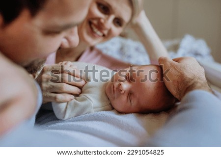 Close-up of parents cuddling their newborn baby. Royalty-Free Stock Photo #2291054825