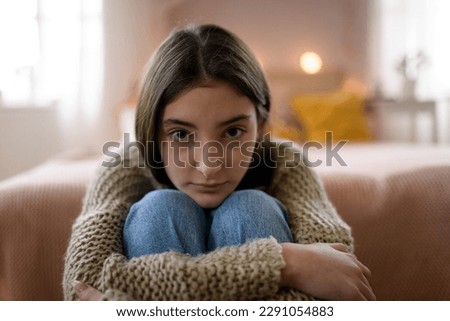Teenage girl sitting on the floor with head on her knees, koncept of mental health. Royalty-Free Stock Photo #2291054883