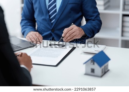 Close up Business people or Real Estate agent explain signing agreement for sale house to client. Property, Insurance, Broker concept