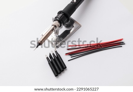 Close up of soldering tips on glass table, silver background with equipment for soldering iron Royalty-Free Stock Photo #2291065227