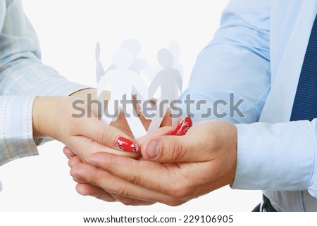 Business people&amp;#39;s hands holding paper people, closeup
