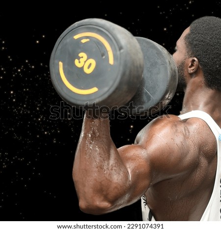 Shredded arms: A strong black male doing a shoulder workout with a heavy dumbbell in a solid black with gold glitter background
