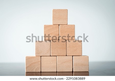 Ten Blank Wooden cubes arranged in a shape of pyramid shaped use for object,business idea.