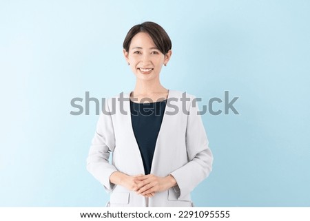 Asian businesswoman on blue background
