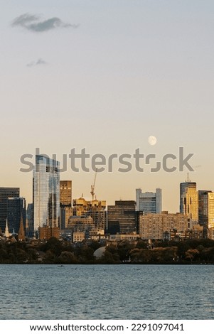 full moon over boston skyline at sunset charles river foreground