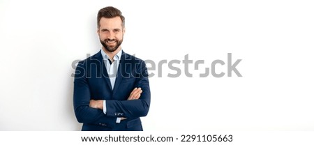 Panoramic portrait of a handsome positive caucasian successful business man in a suit, seo, banker, broker, stand on isolated white background with arms crossed, looks at camera, smiling. Copy-space