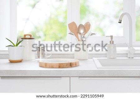 Wooden pedestal on table in kitchen interior with copy space Royalty-Free Stock Photo #2291105949