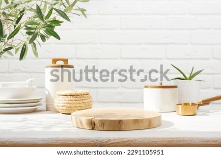 Empty wooden pedestal on kitchen table before white brick wall Royalty-Free Stock Photo #2291105951
