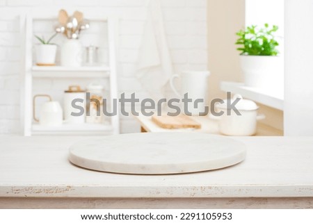 Pedestal for product display on wooden desk and kitchen interior Royalty-Free Stock Photo #2291105953