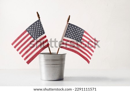 American flags in metal decorative bucket on white background. Concept , backdrop with copy space for USA Independence Day.