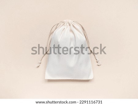 eco-friendly white cotton bag with ties on peach background Royalty-Free Stock Photo #2291116731