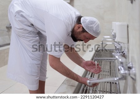 Man muslim perform ablution or wudu at the mosque. Washing before pray Royalty-Free Stock Photo #2291120427