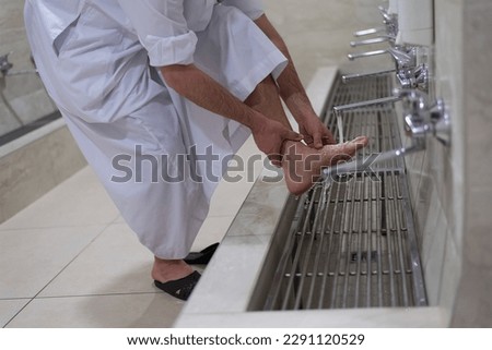 Man muslim perform ablution or wudu at the mosque. Washing before pray Royalty-Free Stock Photo #2291120529