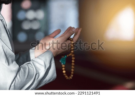 Hand of male muslim praying with mosque interior background during ramadan Royalty-Free Stock Photo #2291121491