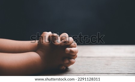 Little boy praying to God with hands held together. Child worship to God. Cute little boy in a Christian family. Royalty-Free Stock Photo #2291128311