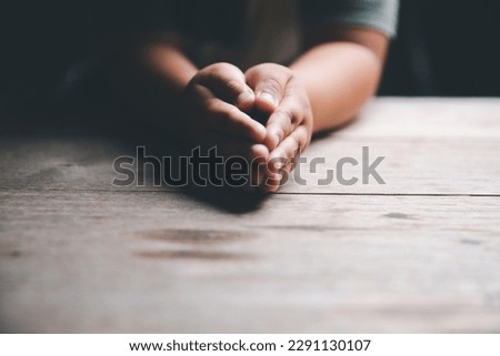 Little boy praying to God with hands held together. Child worship to God. Cute little boy in a Christian family. Royalty-Free Stock Photo #2291130107