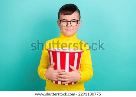 Photo of positive boy hold pop corn bucket enjoying cartoons watching isolated on aquamarine color background