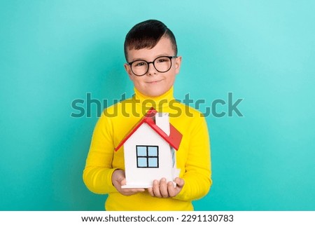 Photo of cute boy hold building house family adoption loan offer concept isolated on cyan color background