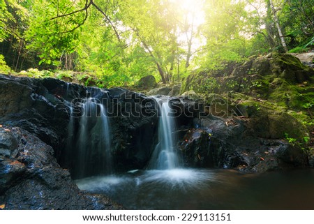 Deep forest waterfall at national park, Thailand.