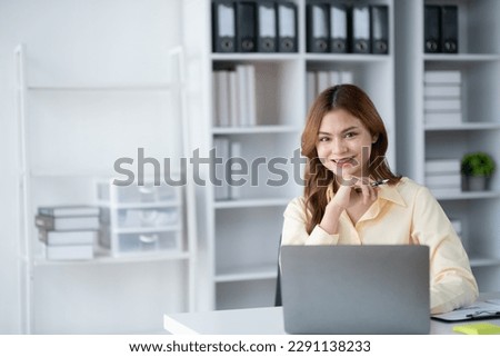 Portrait of young beautiful businesswoman working in her office room.