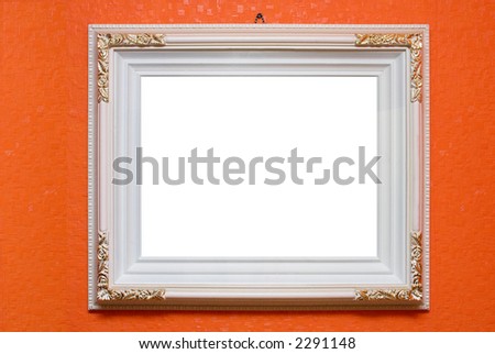 White carved frame dangling on a wall