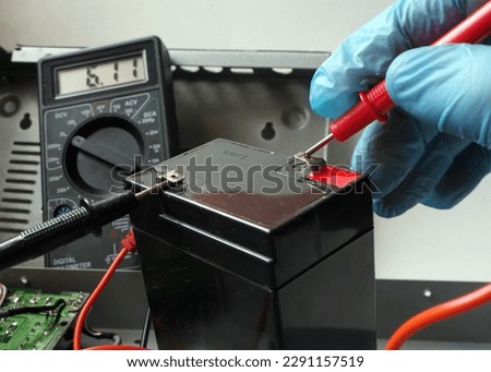 Testing valve regulated lead-acid 6 Volt battery. Full accumulator for UPS.  Royalty-Free Stock Photo #2291157519