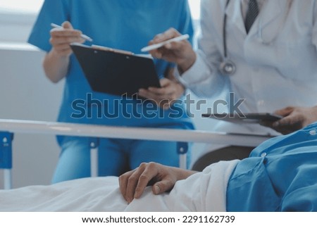 Injured patient showing doctor broken wrist and arm with bandage in hospital office or emergency room. Sprain, stress fracture or repetitive strain injury in hand. Nurse helping customer. First aid. Royalty-Free Stock Photo #2291162739