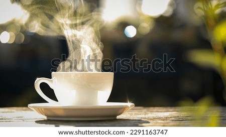Concept Coffee Cup, Mug, hot drink, espresso, breakfast. close-up natural steam smoke of coffee from hot coffee cup on old wooden table in morning warm sunlight flare, outdoor background Royalty-Free Stock Photo #2291163747