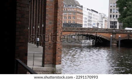 Outdoor corridor with red brick columns next to modern building in Hamburg, Germany