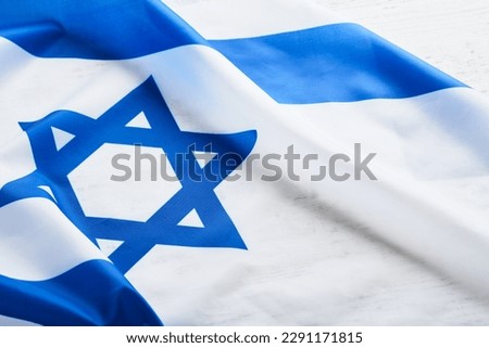 Independence Day of Israel. National Israel flag with star of David over white wooden background. Close up. National flag with place for text. Royalty-Free Stock Photo #2291171815