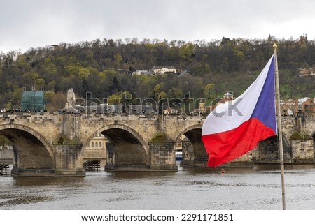 Czech flag with Charles Bridge in the background.