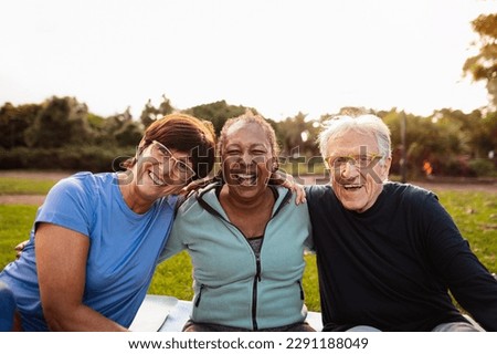 Happy multiracial senior friends having fun smiling at the camera after training activities in the park Royalty-Free Stock Photo #2291188049
