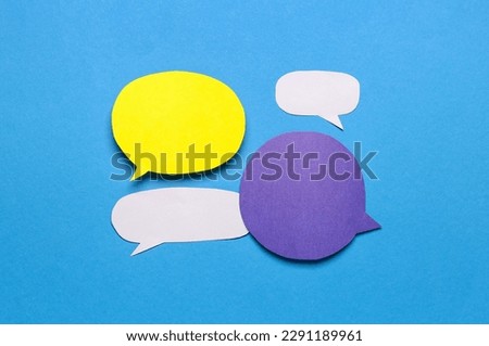 Blank paper speech bubbles on blue background
