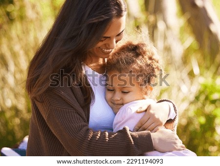 I love you. an attractive young woman and her daughter sharing an intimate moment during their picnic in the park.