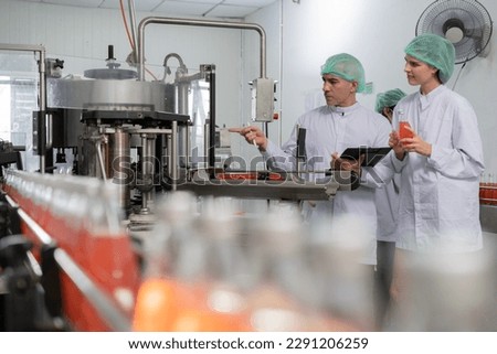 A quality supervisor or food or beverages technician discuss about process control of food and drugs before send product to the customer. Production leader recheck ingredient and productivity. Royalty-Free Stock Photo #2291206259