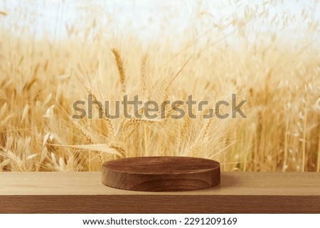Empty wooden podium on table over wheat field background.  Jewish holiday Shavuot mock up for design and product display. Royalty-Free Stock Photo #2291209169
