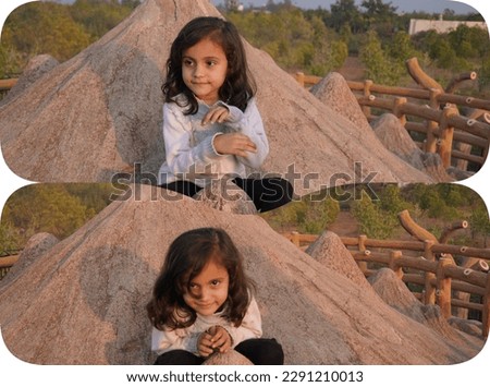 Kid playing outdoor with portrait photo filter effect. Beautiful brown hair and hands different style.