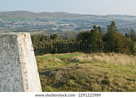 View to Kilsyth and the Kilsyth Hills from the John Muir Way walking trail at the triangulation pillar on Bar Hill summit above Twechar, East Dunbartonshire, Scotland. Royalty-Free Stock Photo #2291222989