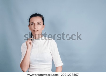 Thin middle-aged woman on gray background