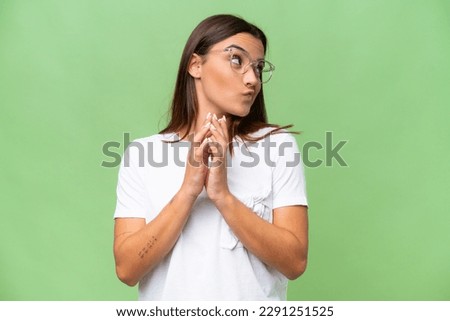 Young caucasian woman isolated on green chroma background scheming something Royalty-Free Stock Photo #2291251525